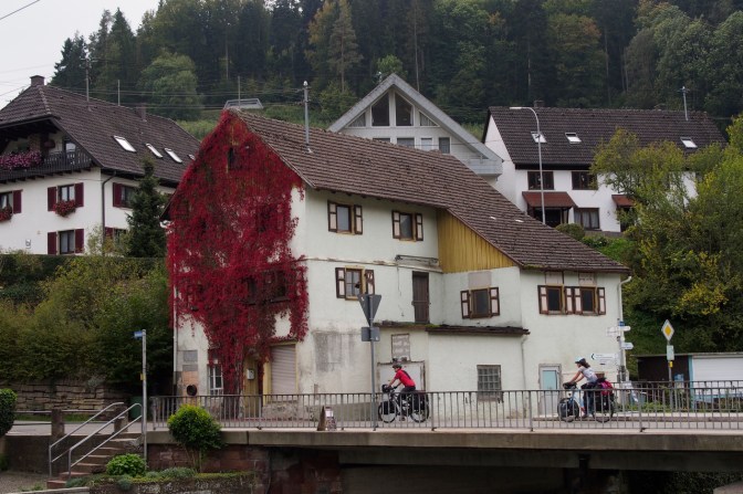 Jan and Tom riding through a village in the Black Forest.