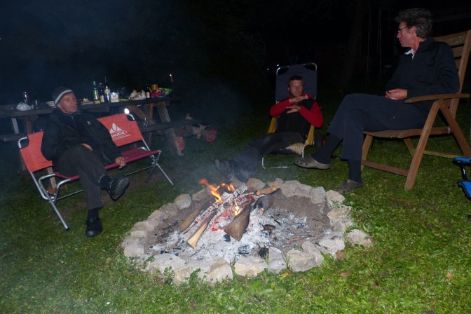 Tom, Wolfi and Paul drinking beer by the fire.