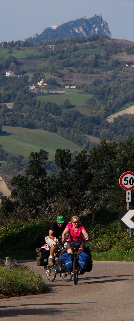 With San Marino in the background, Ivona and Gary climbing up from Mercatino Conca on the way to Urbino.