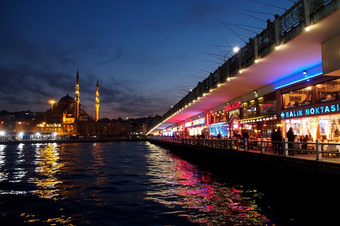 Galata Bridge Restaurants across the Golden Horn with Yeni Cami, the New Mosque, in the background.