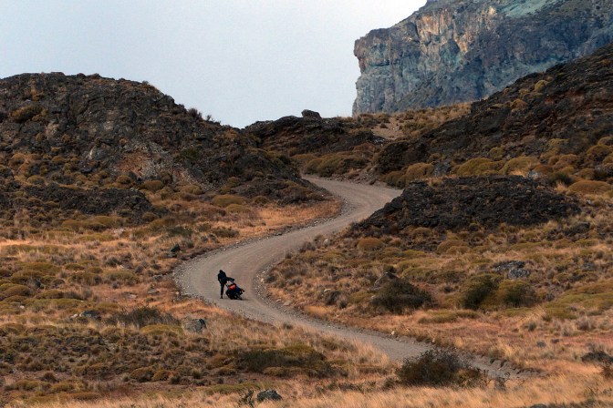 Paul is thrown off his bike as it slips out from under him in the soft gravel on a steep hill in the Chacabuco Valley.
