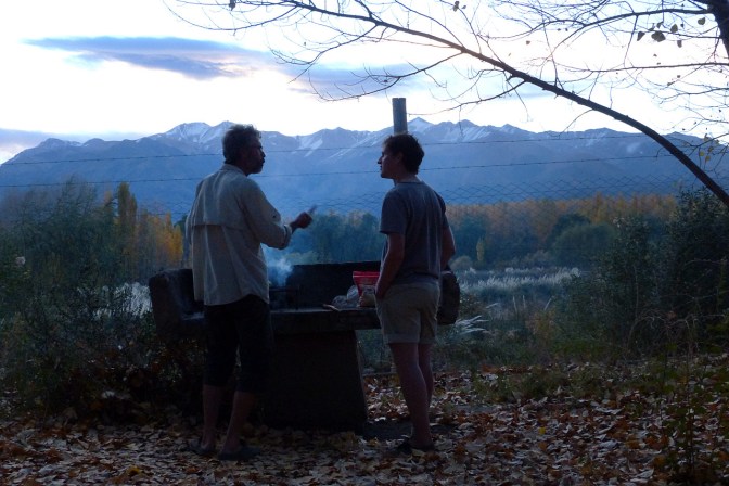 Paul and Cyrille chatting by the grill as the sun sets.