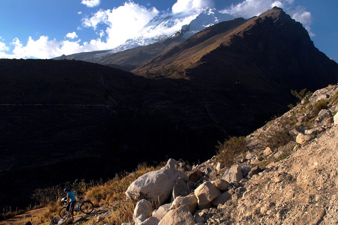 Jan hiking her bicycle down off the road to a camp spot.