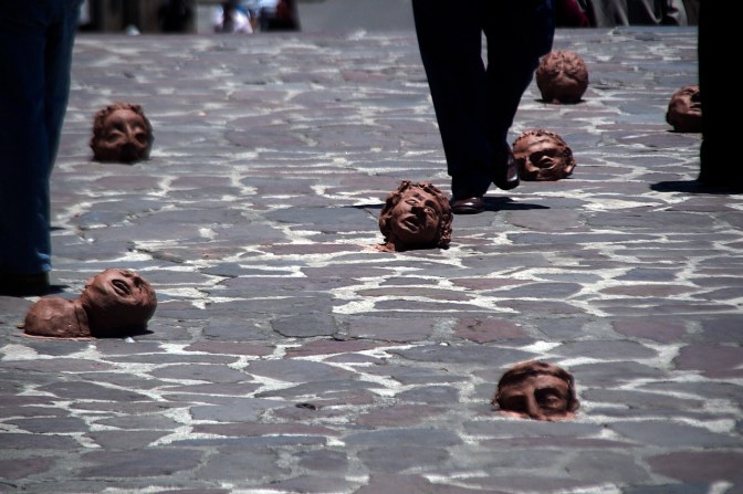Pedestrians walk through a guerrilla art installation in Plaza San Fransisco.