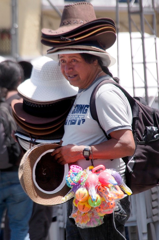 Selling hats, a much needed accessory to shield the intense equatorial sun.