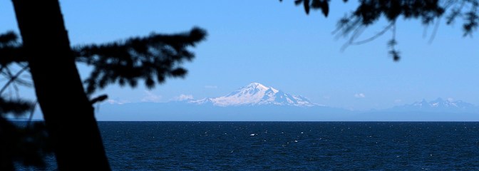 Mount Baker looms on the horizon 130 km away.